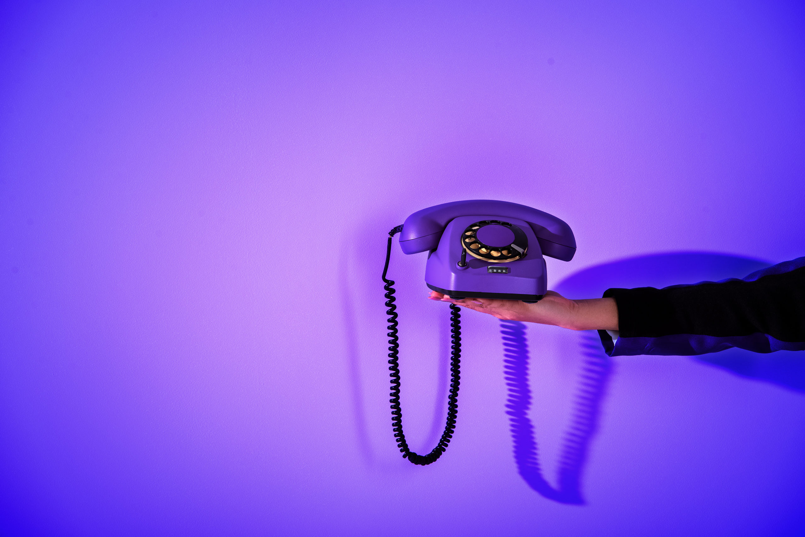 Hand Holding Purple Phone With Purple Background